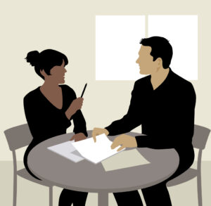 Drawing of a male-and-female-couple at a table discussing paperwork