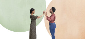 A Black woman and an Indian woman playing pattycake